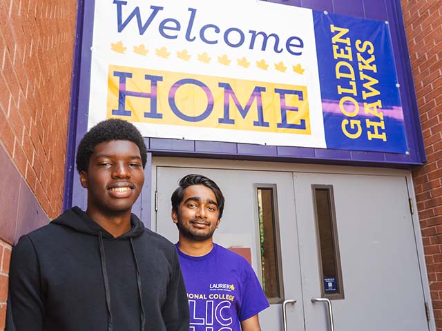 Two WLIC students standing in front of a banner that reads