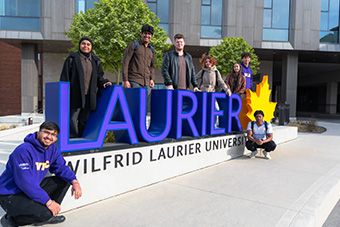 WLIC students around Laurier sign